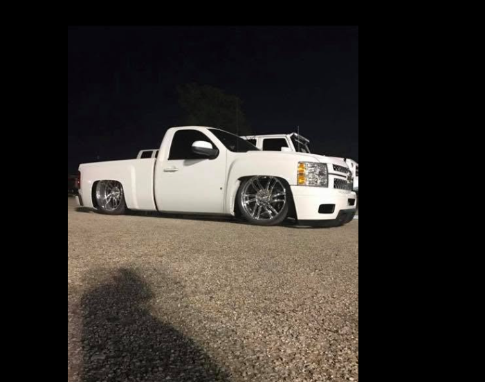 White lowered Chevrolet truck at night