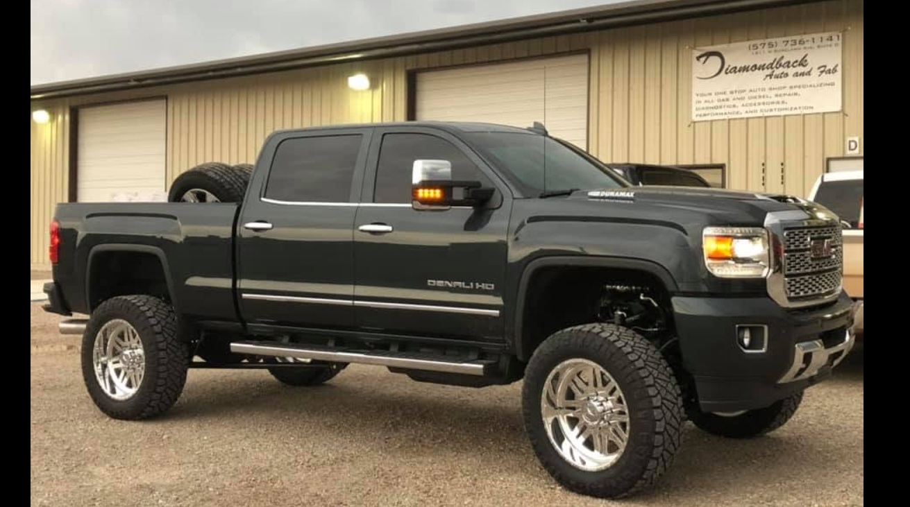 Black lifted GMC Denali truck
